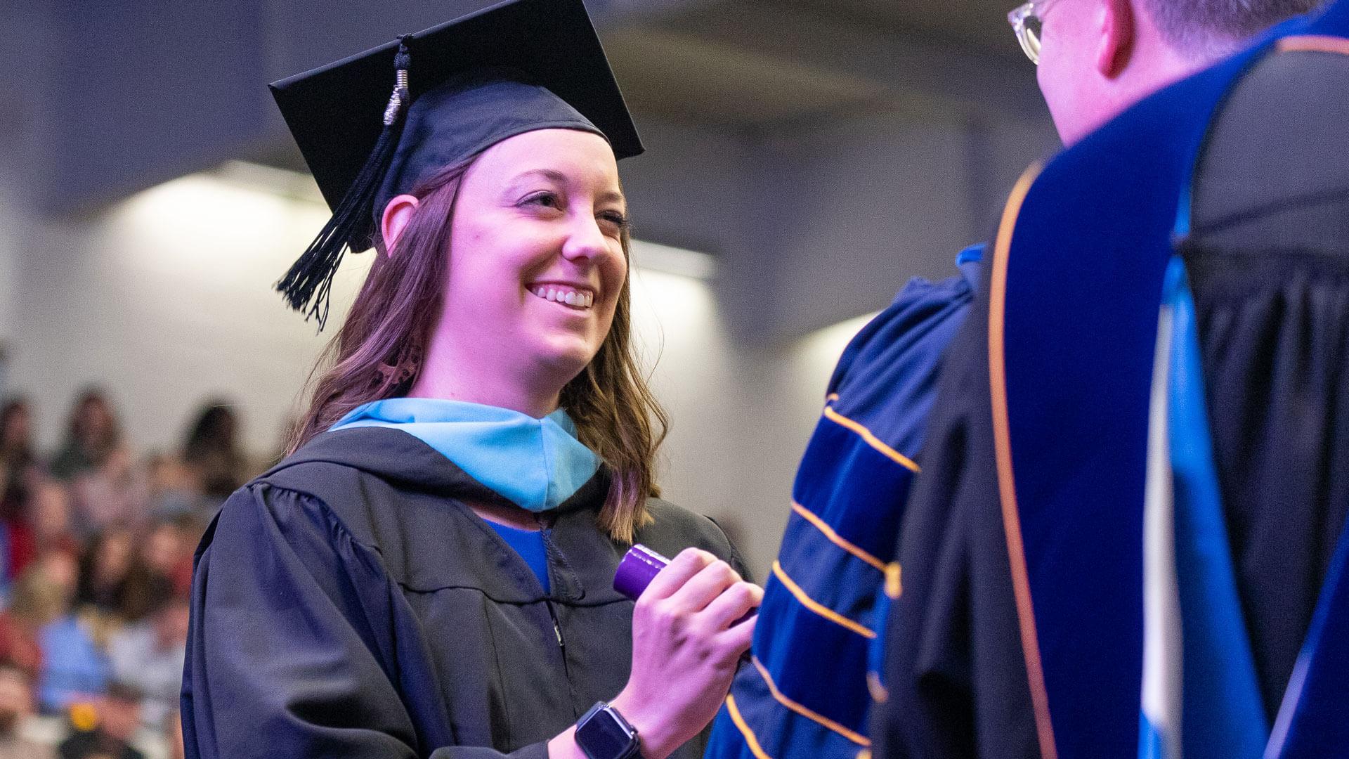 master's in education graduate receives diploma